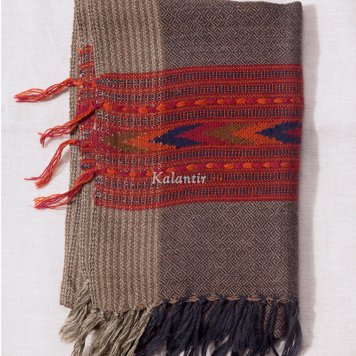 Folded Grey colour Kullu Woollen muffler with red geometric pattern.